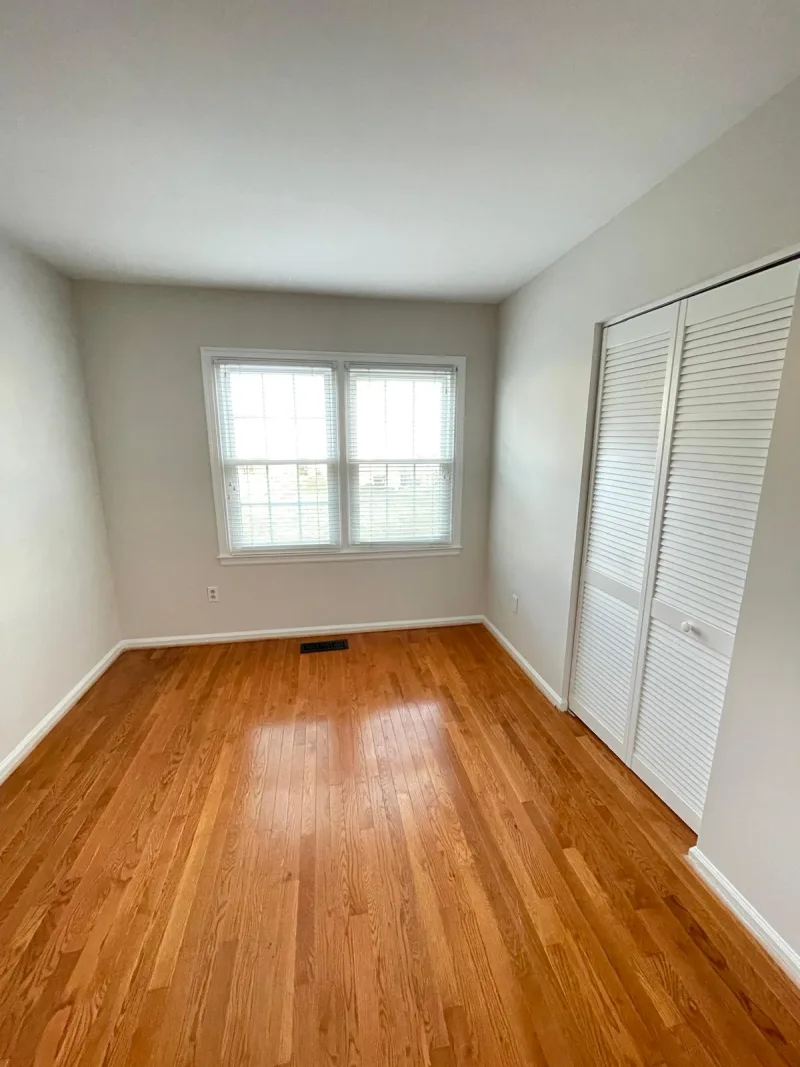 Bright, empty bedroom with clean hardwood floors