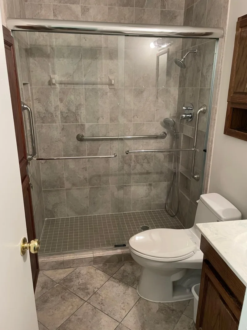 Clean bathroom with a tiled walk-in shower and glass door