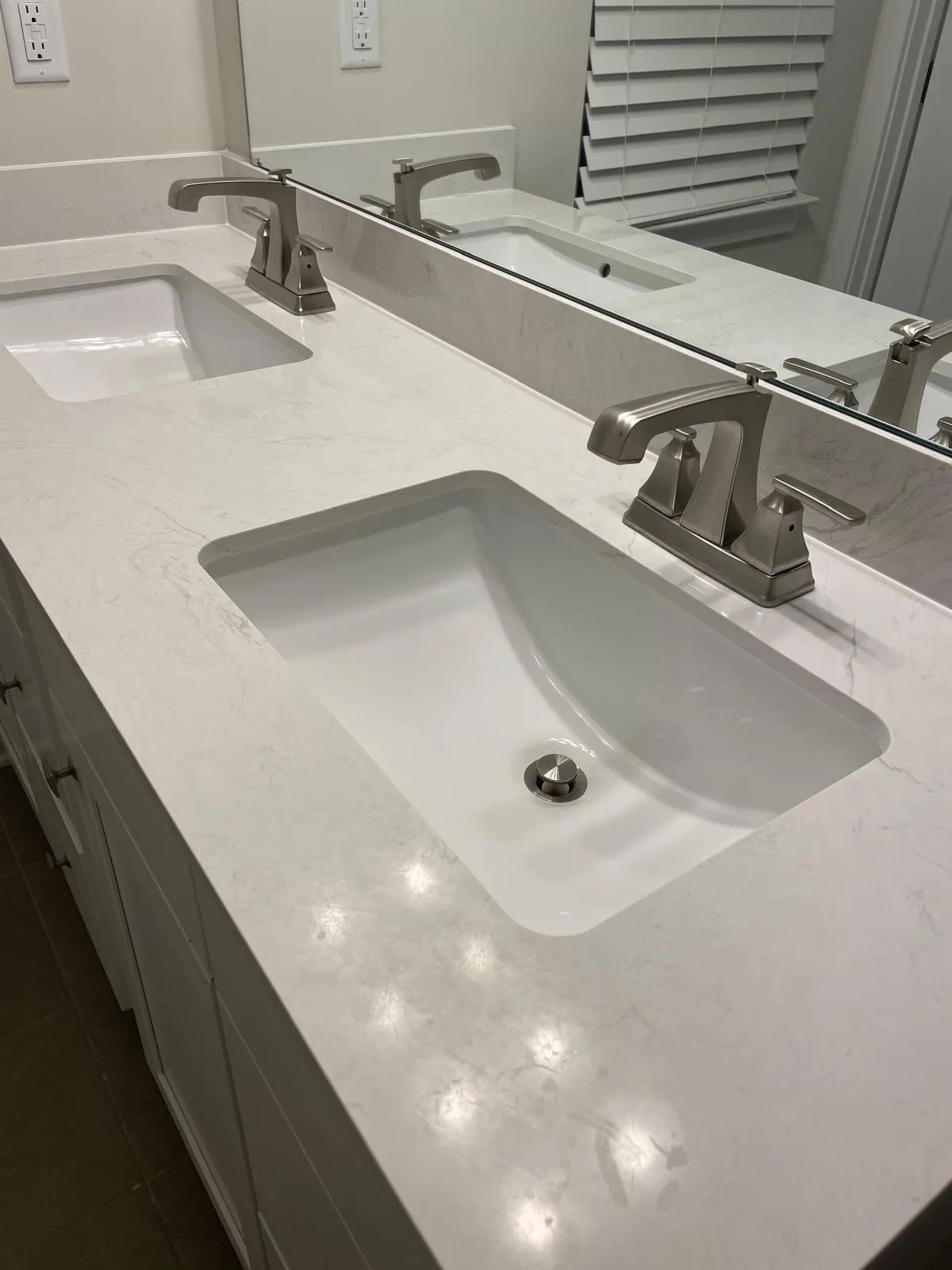 Polished bathroom faucet and sink on a clean white countertop